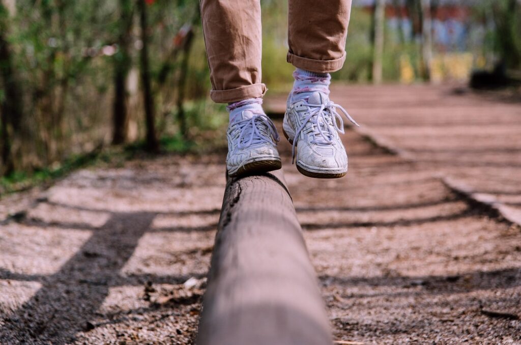 hiker's feet in cushioned socks and trail shoes resting at a scenic mountain overlook