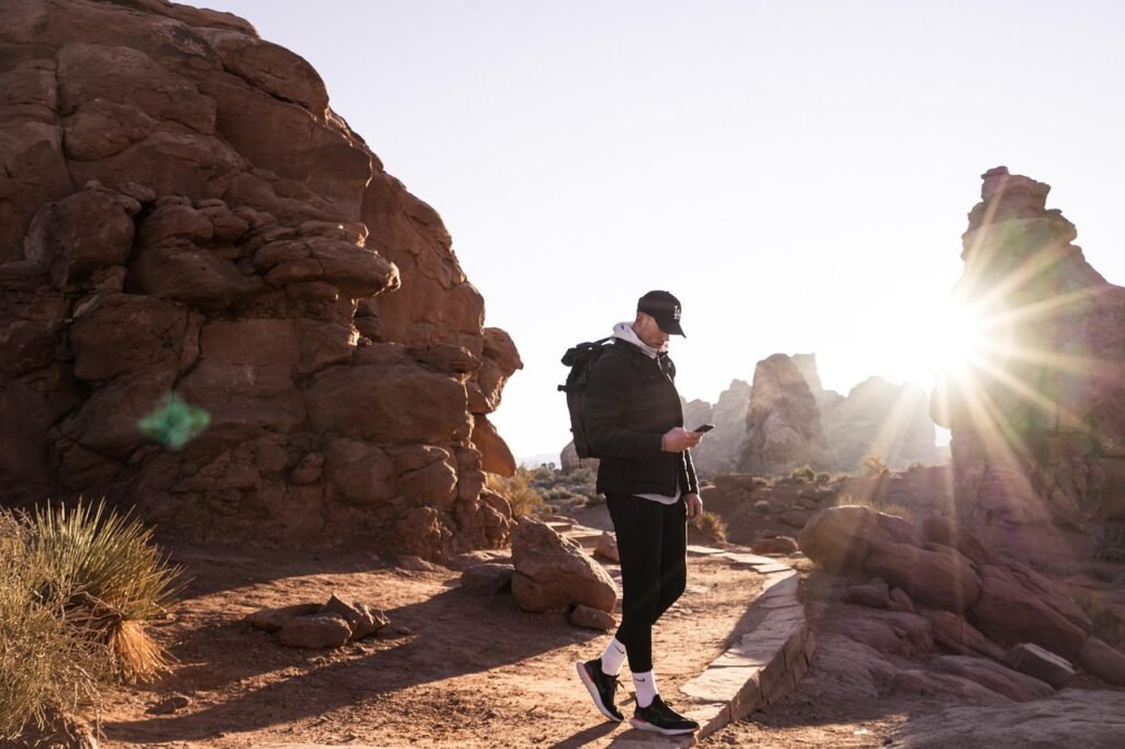 hiker organizing emergency supplies inside a backpack at a campsite